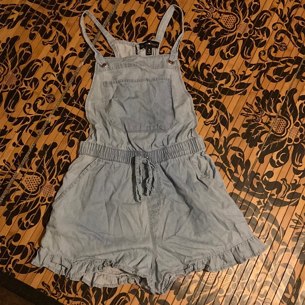 Super cute country overalls with a ruffled bottom.